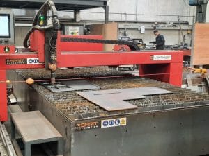 CNC plasma cutting machine in a steel fabrication workshop, actively cutting sheet metal at Riteweld Engineering.