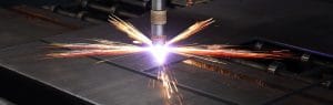CNC plasma cutter slicing through a steel plate with bright sparks, captured during high-precision cutting at Riteweld Engineering.