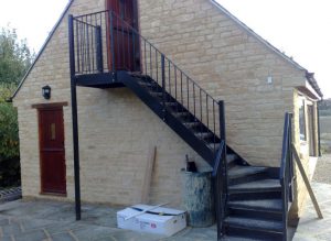 Steel straight staircase on side of building