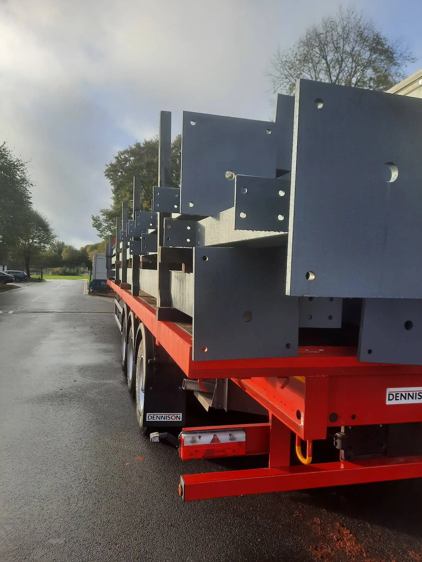Fabricated steel sections stacked on a red flatbed trailer, prepared for site delivery by Riteweld Engineering.