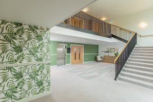 Modern internal steel stair balustrade with oak handrail installed by Riteweld Engineering at a luxury Cotswolds hotel, blending clean lines with natural finishes.