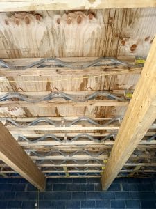 Glulam beams supporting Posi-Joist floor joists within a residential building, forming part of the engineered timber floor structure.